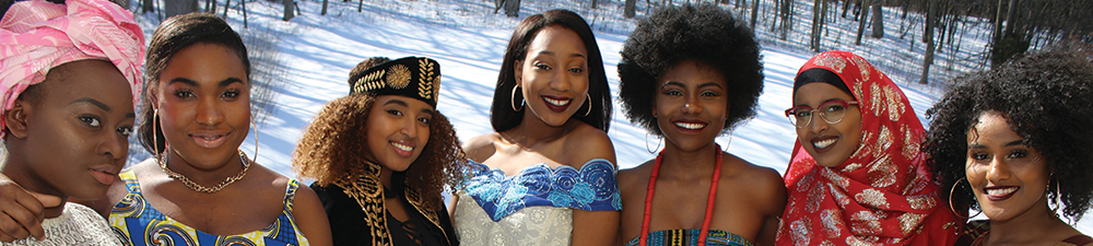 Seven women looking at camera smiling