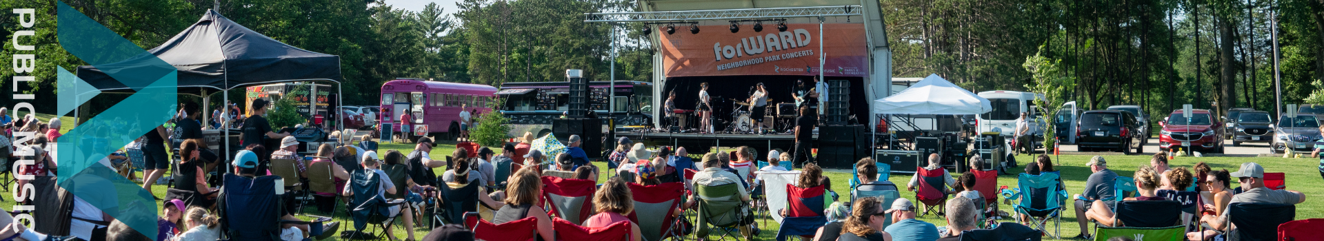 Forward concert banner with a large crowd watching the performers on stage.